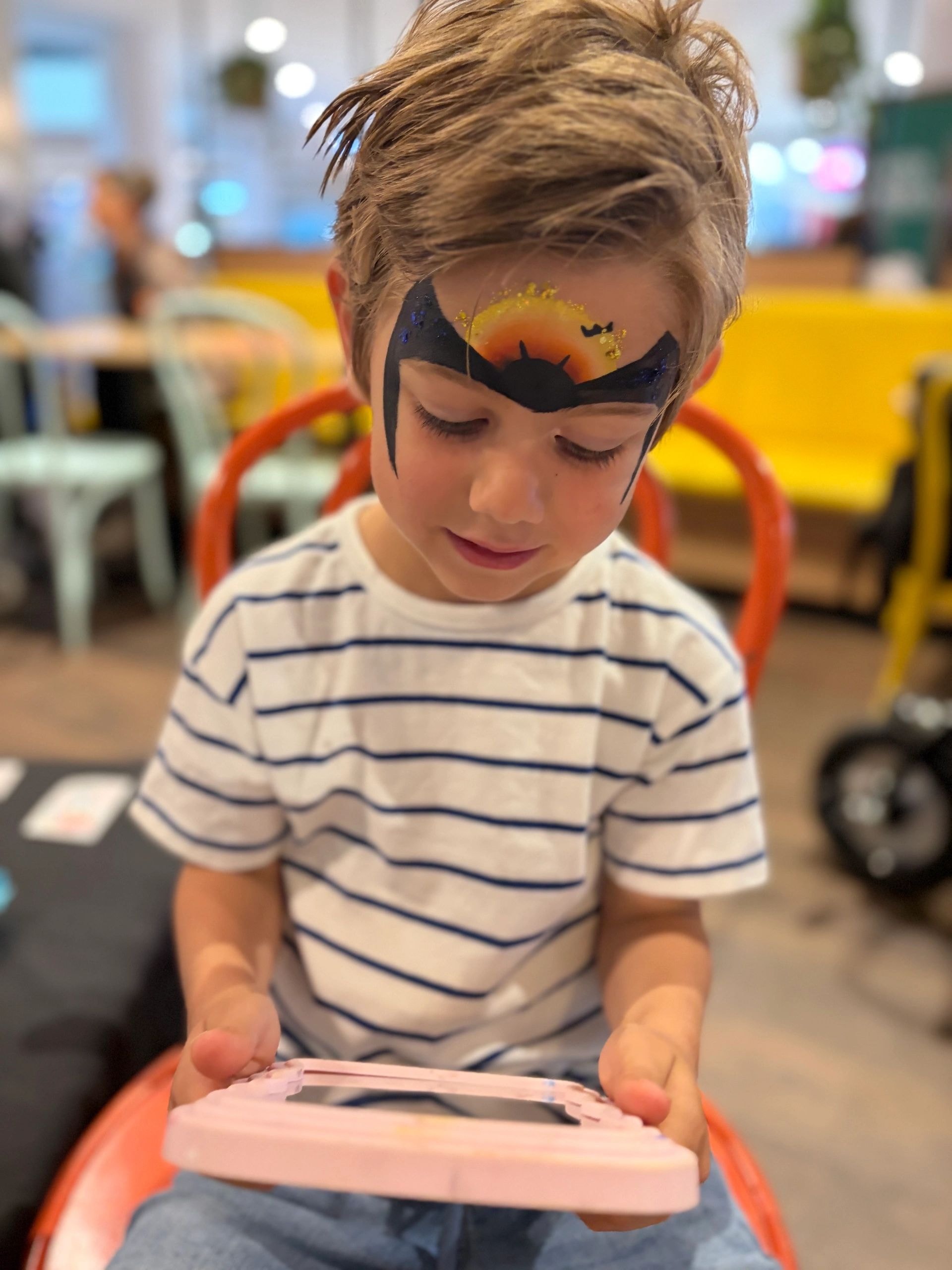 Child with bat face paint
